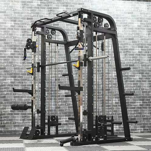 A multi-functional gym machine with pulleys and bars stands on a patterned mat against a brick wall. It features various attachments for weight training and resistance exercises. The frame is sturdy and black with some yellow accents.