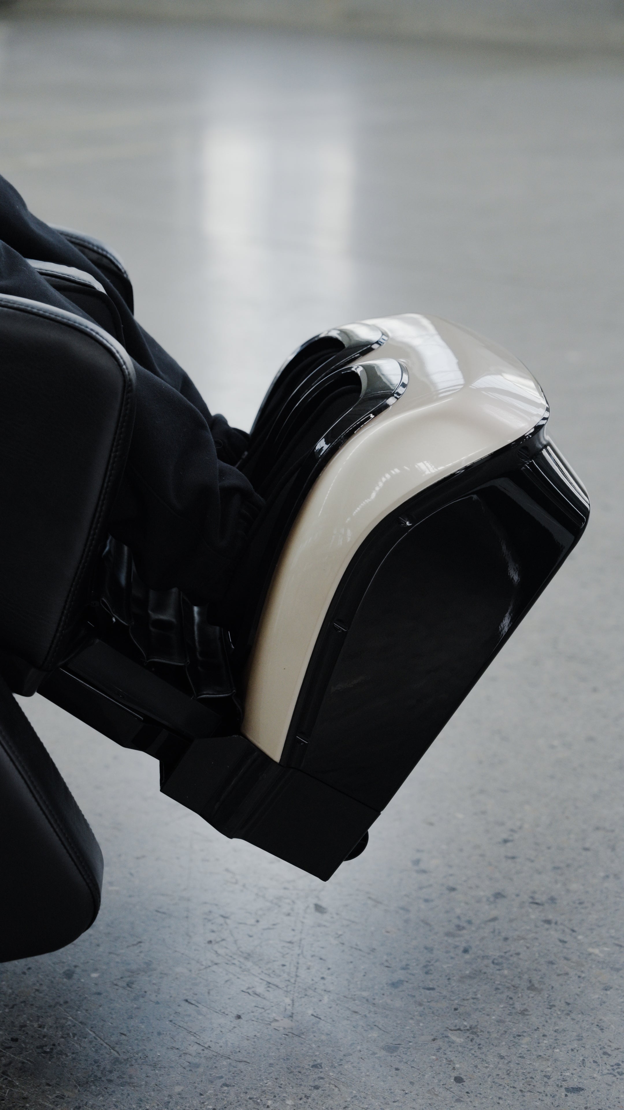 A close-up of a person’s lower legs and feet inside the BefitNow Canada 4D SL Luxury Voice Control Custom Massage Chair, offering deep tissue massage, on a gray floor.