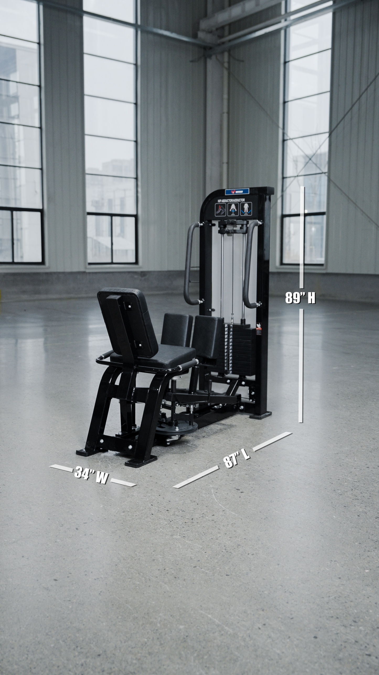 The BefitNow Canada HS32 Abductor/Adductor gym machine, in black with a weight stack, sits in a spacious room with large windows. White text displays its dimensions: 34" wide, 87" long, and 89" high.