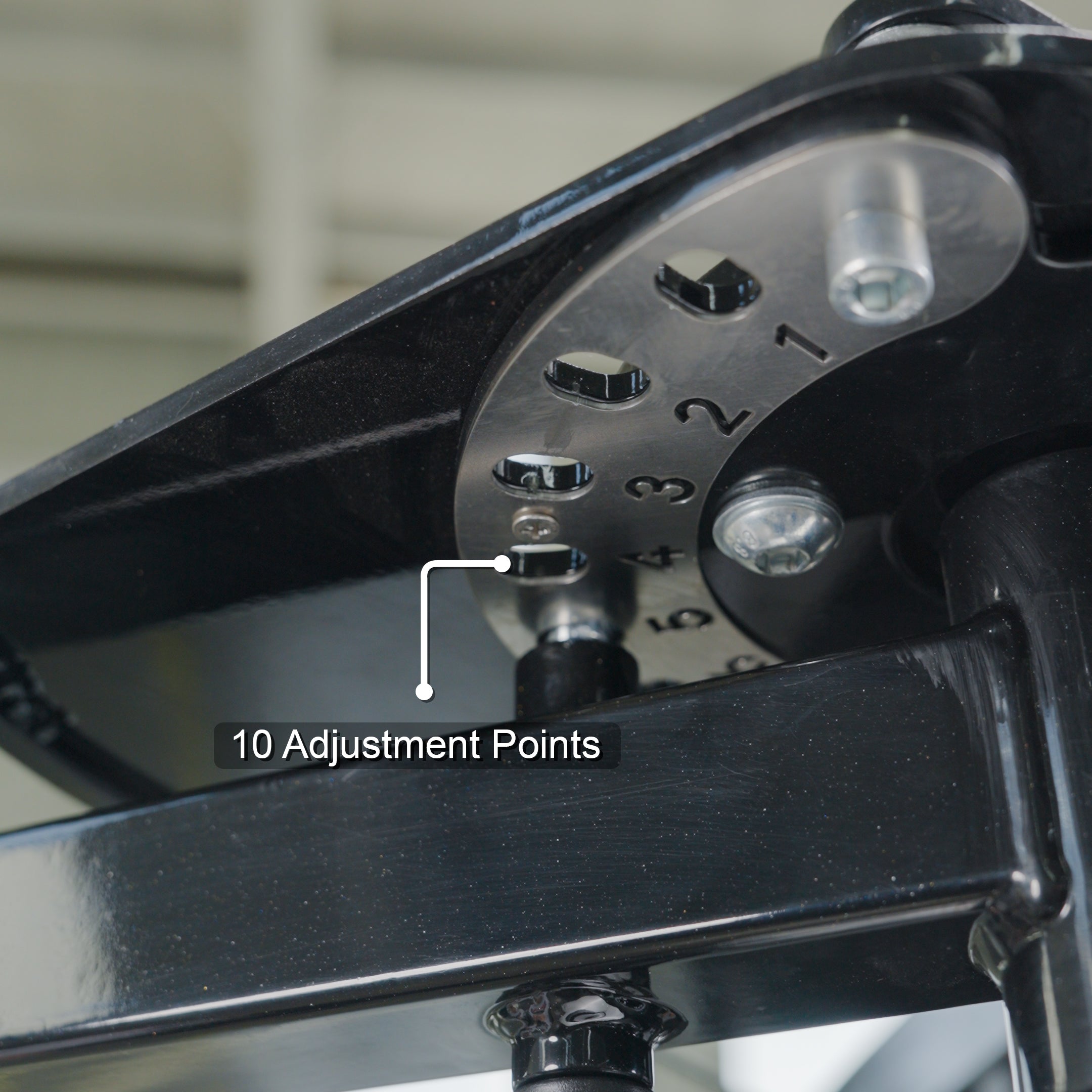 Close-up of a metal part on the BefitNow Canada Pearl Delt/Pec Fly, showing a steel adjustment plate numbered 1–10 with holes for settings. A label points to the plate, reading “10 Adjustment Points.”.