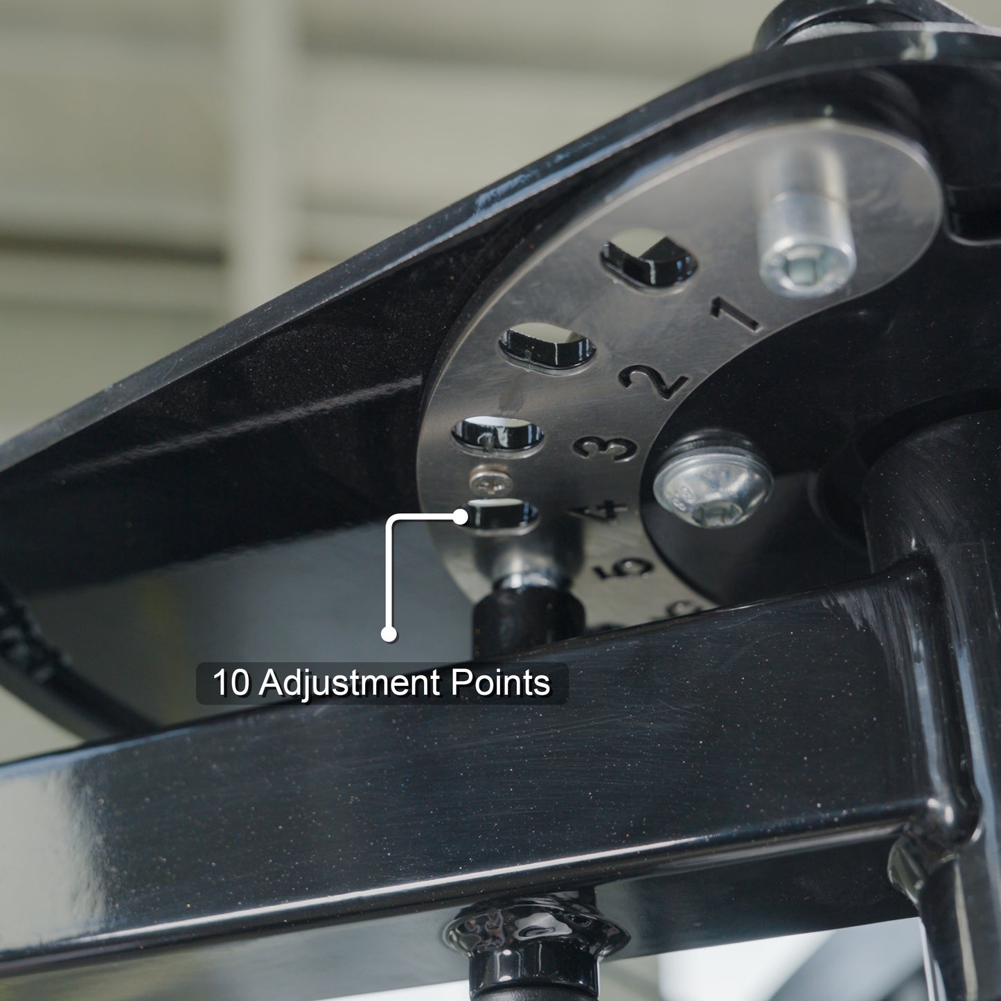 Close-up of a metal part on the BefitNow Canada Pearl Delt/Pec Fly, showing a steel adjustment plate numbered 1–10 with holes for settings. A label points to the plate, reading “10 Adjustment Points.”.