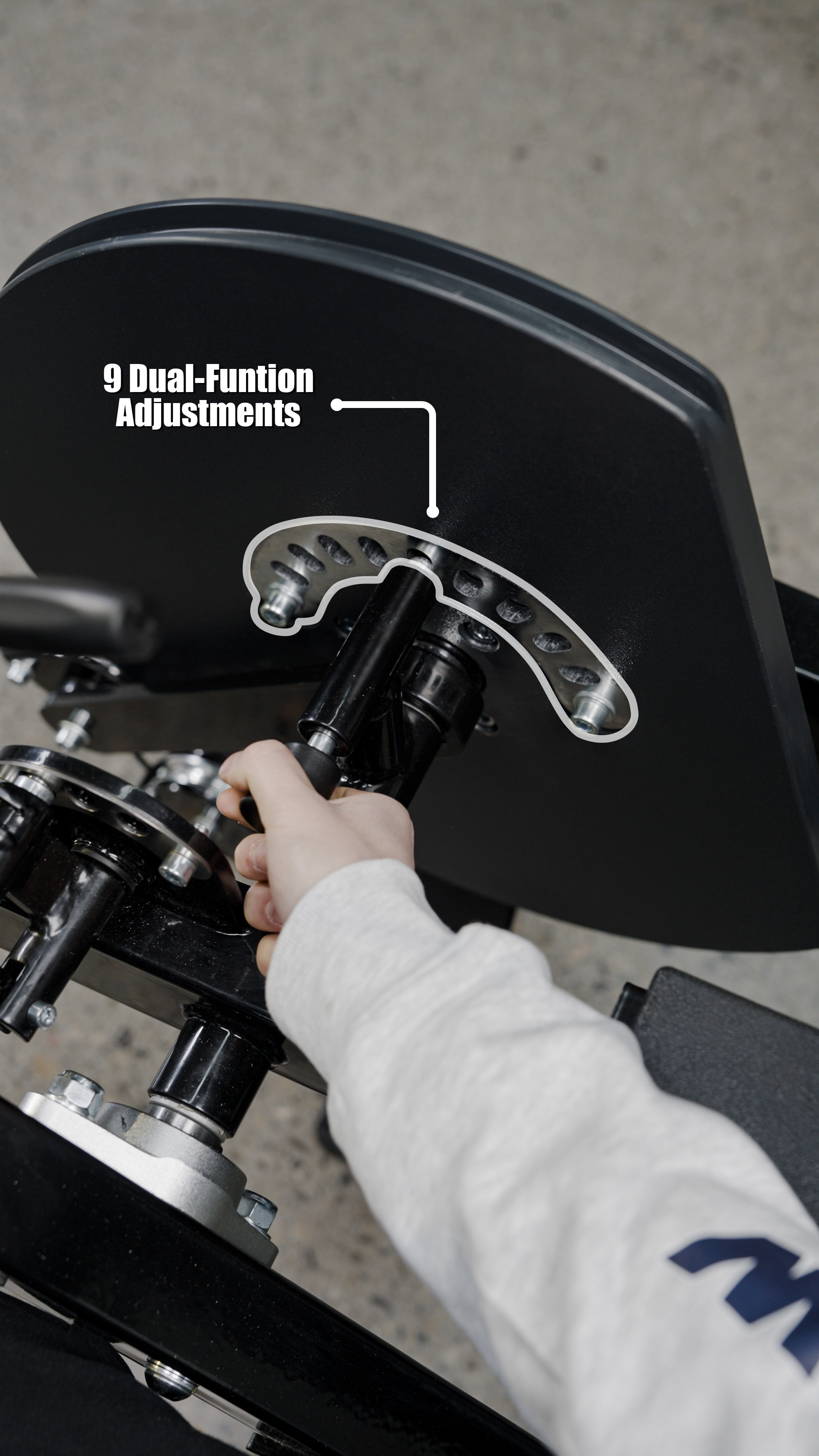 A user adjusts the backrest of the BefitNow Canada Dual Function Leg Extension Leg Curl Machine, showing 9 labeled dual-function adjustment holes and an arrow highlighting the adjustment mechanism.