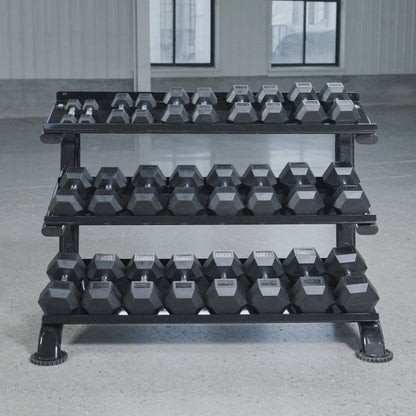 The BefitNow Canada 3 Tier Commercial Hex Dumbbell Rack, loaded with black hex dumbbells, stands on a gray gym floor with large windows, offering efficient organization for your workout space.