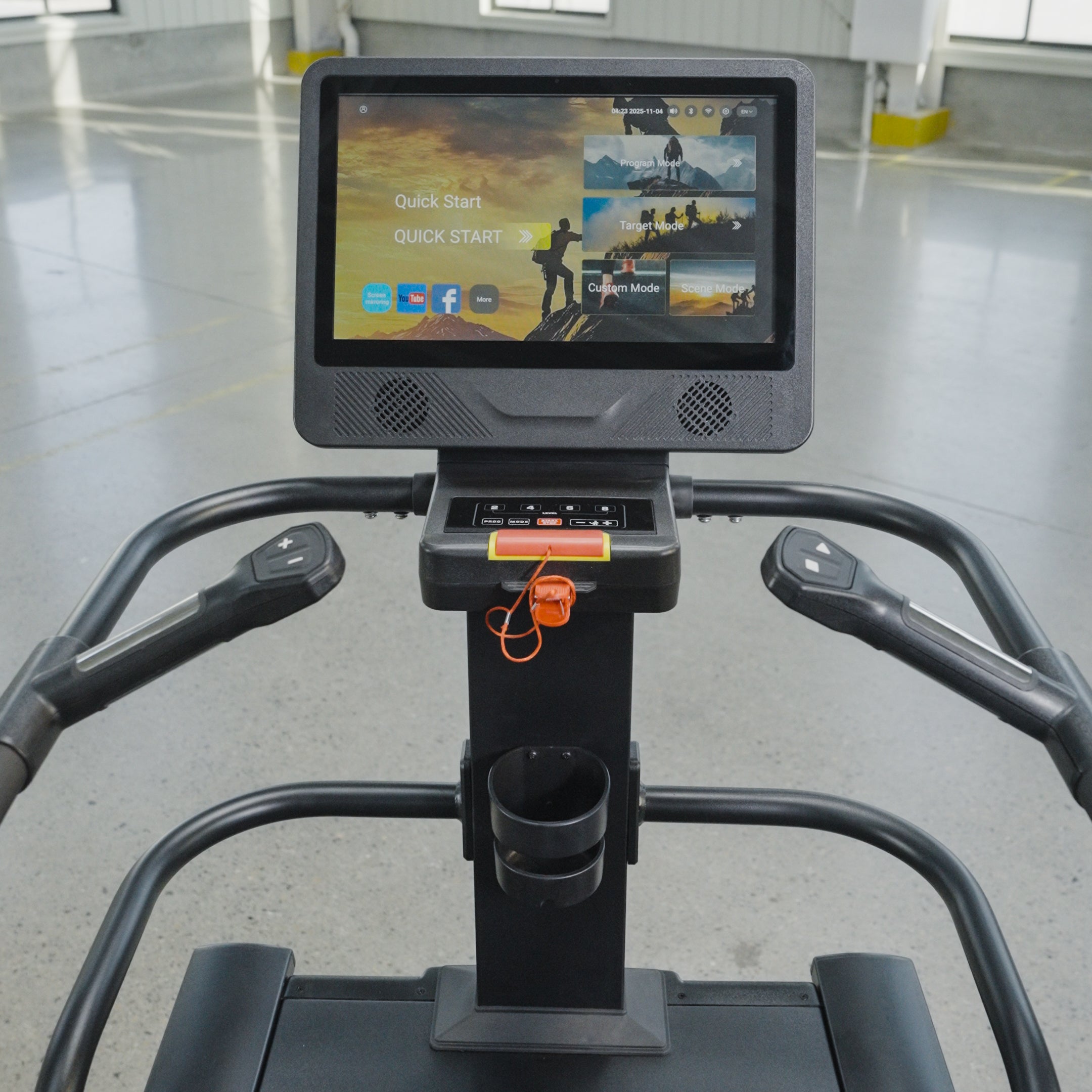 Close-up view of The SkyStep Stair Climber's interactive touchscreen console by BefitNow Canada, offering workout options. Perfect for cardio training, it stands in a spacious, well-lit gym with a gray floor and yellow markings.