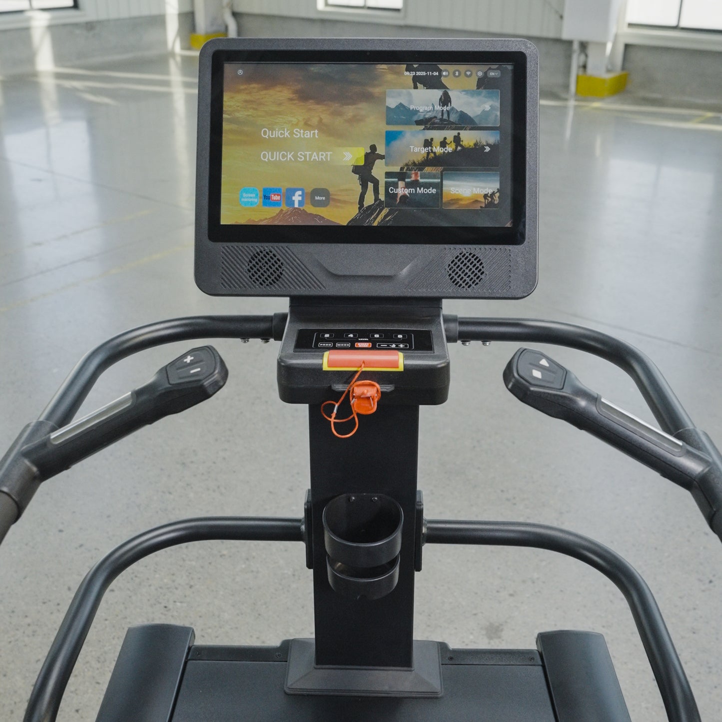 Close-up view of The SkyStep Stair Climber's interactive touchscreen console by BefitNow Canada, offering workout options. Perfect for cardio training, it stands in a spacious, well-lit gym with a gray floor and yellow markings.
