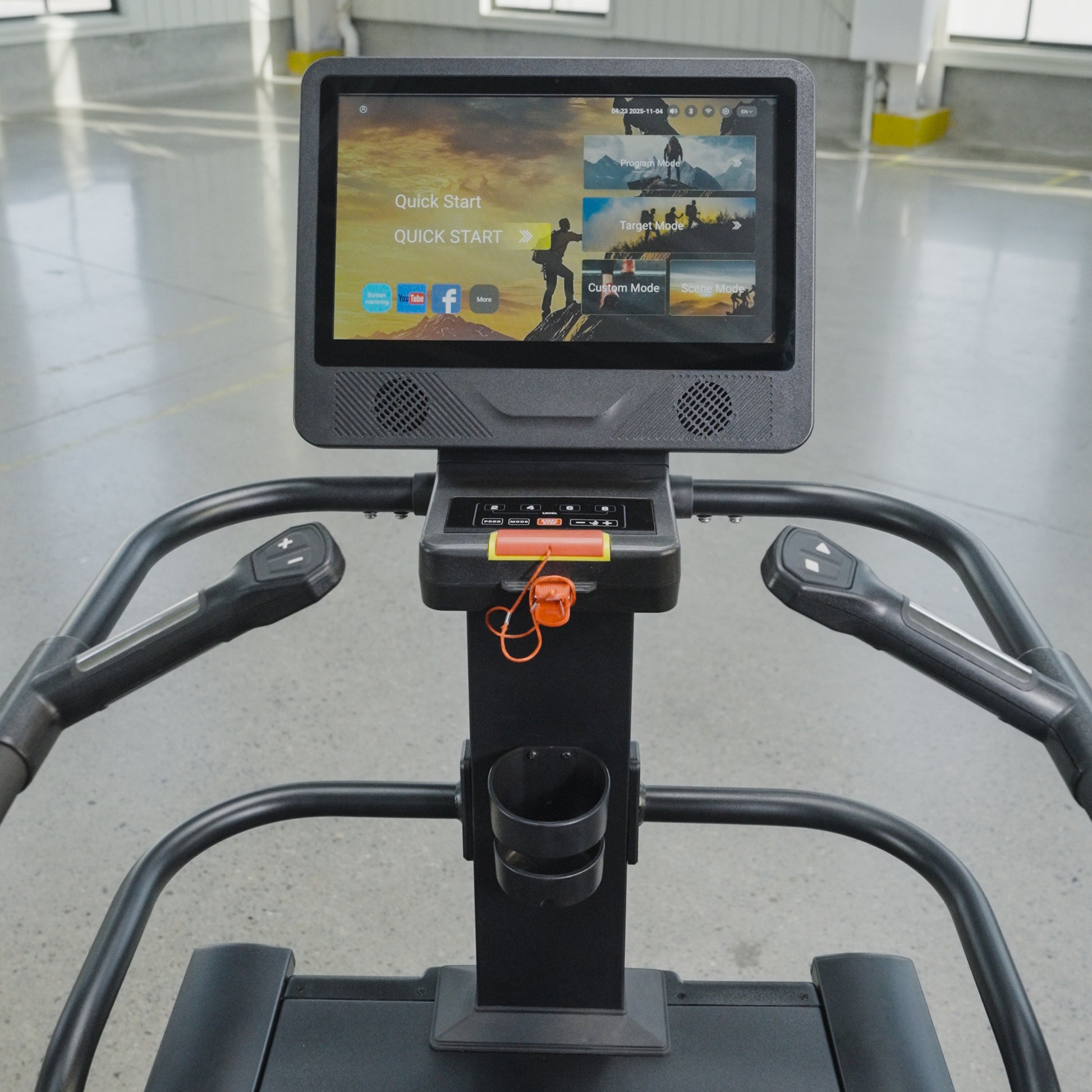 Close-up view of The SkyStep Stair Climber's interactive touchscreen console by BefitNow Canada, offering workout options. Perfect for cardio training, it stands in a spacious, well-lit gym with a gray floor and yellow markings.