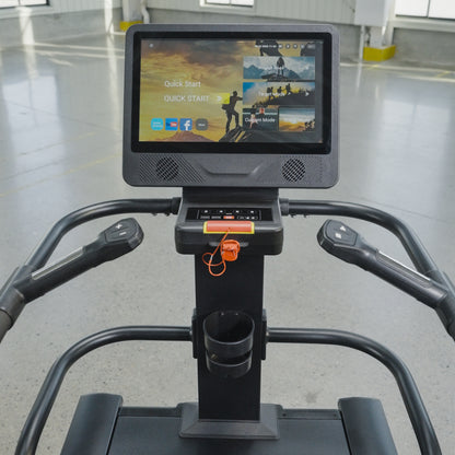 Close-up view of The SkyStep Stair Climber's interactive touchscreen console by BefitNow Canada, offering workout options. Perfect for cardio training, it stands in a spacious, well-lit gym with a gray floor and yellow markings.
