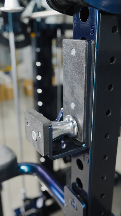 Close-up of a metal adjustment pin in the numbered holes of The Professor all-in-one trainer power rack by BefitNow Canada, used to set attachment height for home gym equipment.