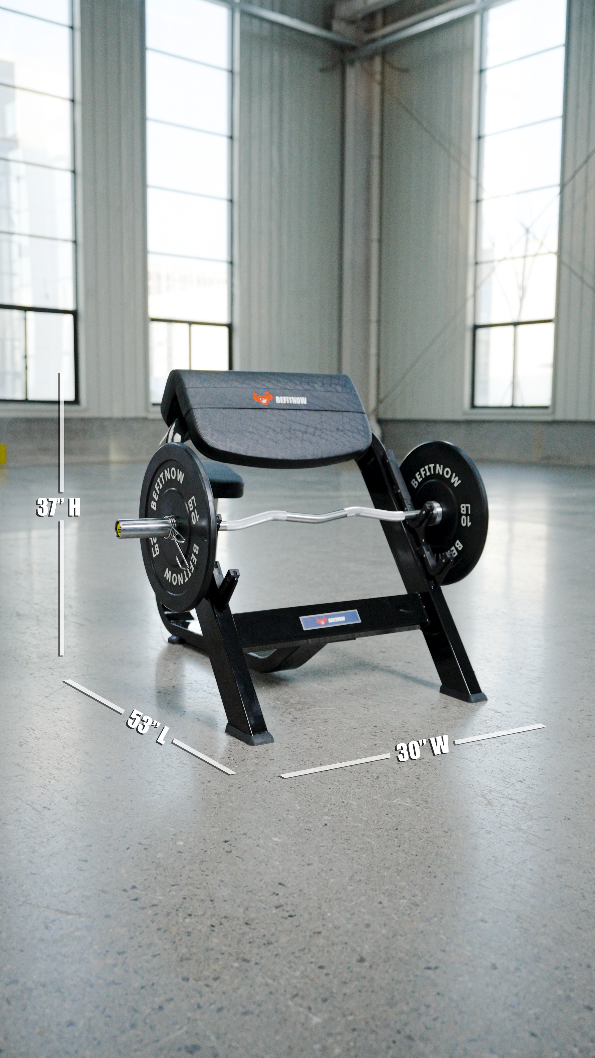 The BefitNow Canada Seated Preacher Curl Bench rests on a concrete floor in a sunlit gym. White lines show its dimensions—53"x30"x37"—making it ideal for focused arm workouts with barbells and weights.