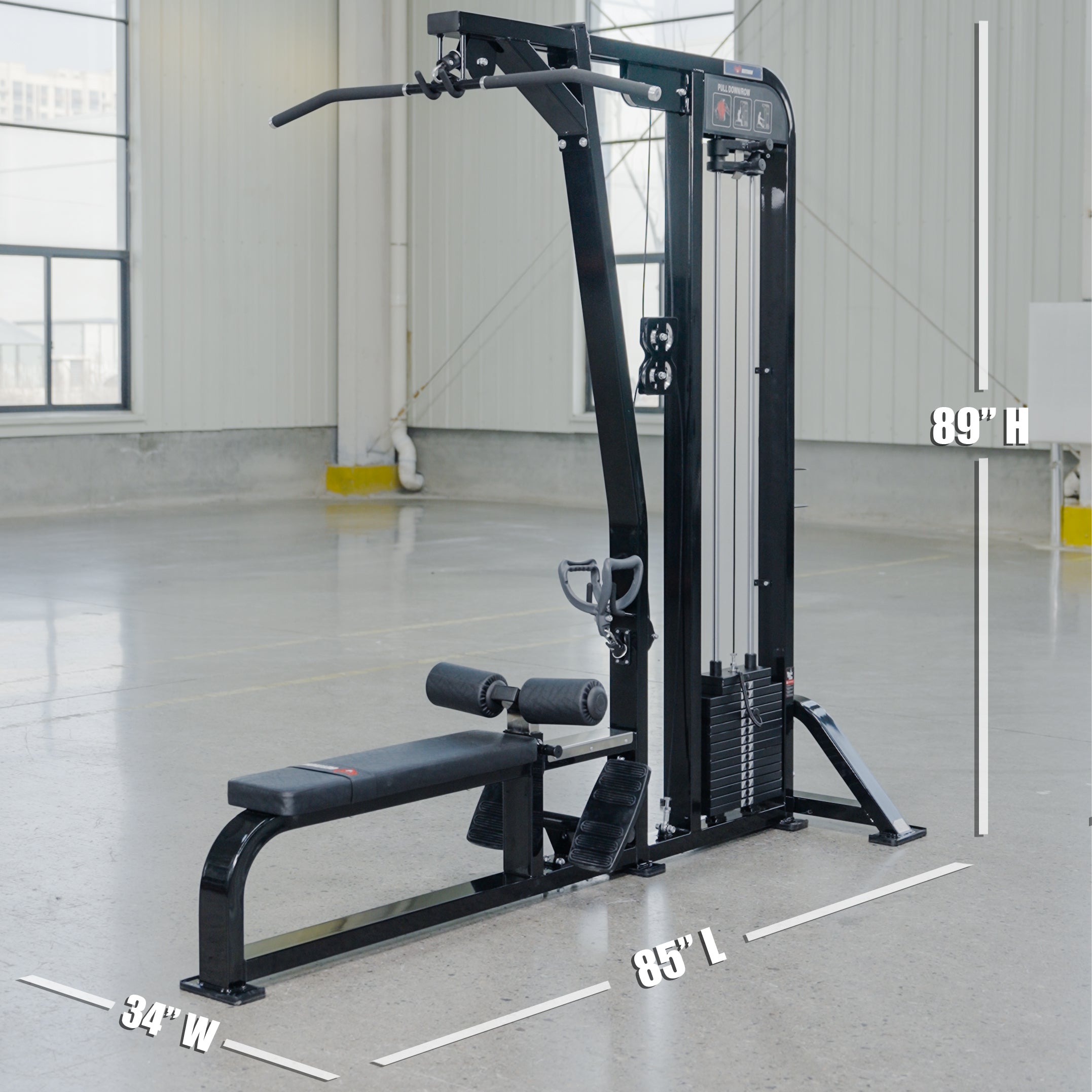 The BefitNow Canada Lat Pulldown/Low Row, in black with a padded bench, vertical weight stack, and pull-down bar, measures 34W x 95L x 89H. It's shown in a spacious room with concrete floors and large windows.