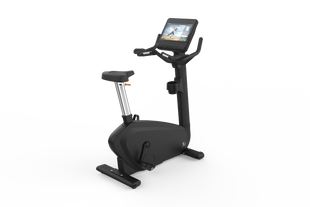 The Shua B9100UT Commercial Upright Bike is a black stationary exercise bike with a large TFT screen showing a workout video and electromagnetic control, set against a white background.