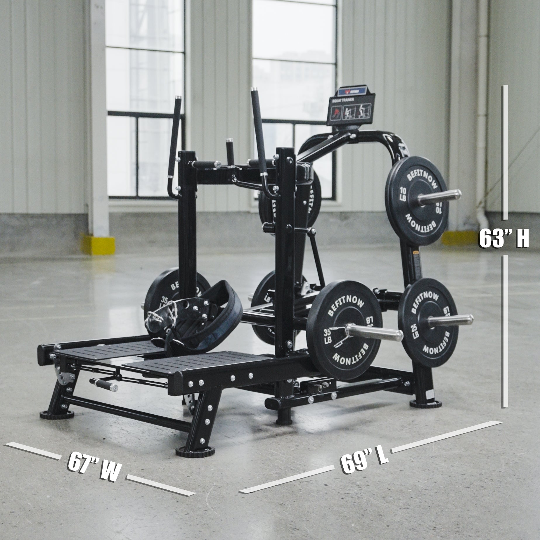 The BefitNow Canada Commercial Belt Squat Trainer stands in a bright indoor space, featuring weight plates and labeled dimensions of 63" high, 67" wide, and 69" long.