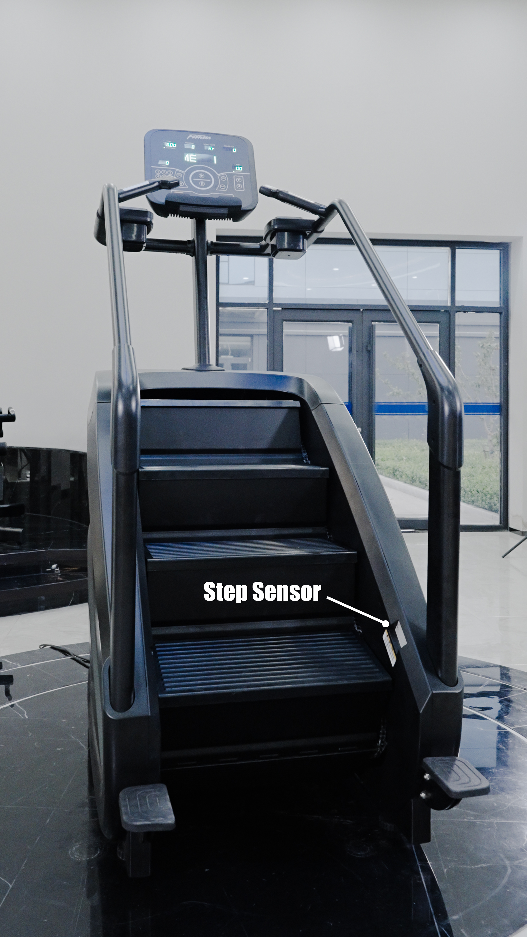 The BefitNow Canada Stair Climber 3000 – The Peak Punisher is a black, commercial-grade machine with joint-safe climbing tech, a top-mounted control panel, and a Step Sensor label. Large windows create a bright backdrop.