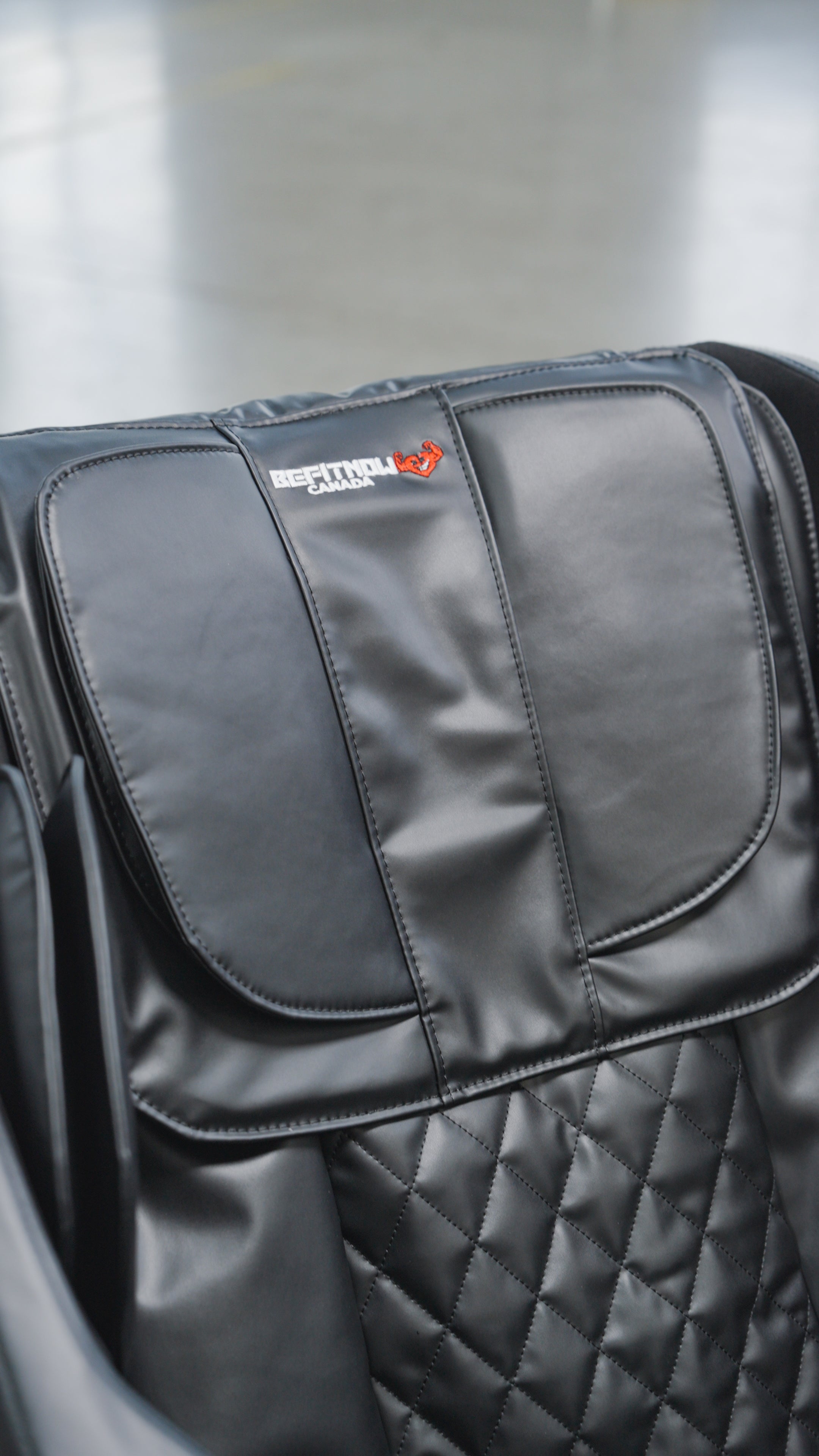 Close-up of a black leather seat with quilted stitching and a headrest featuring the embroidered "Special Edition" text and logo on the BefitNow Canada Luxurious Zero Gravity Massage Chair. Background is blurred.