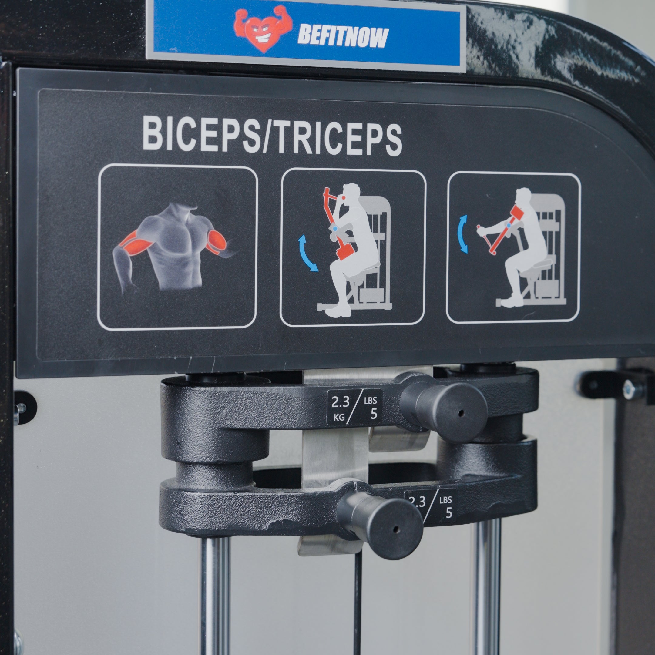The BefitNow Canada Dual Function Biceps/Triceps machine is designed for arm training, with illustrated usage instructions and adjustable resistance knobs below the panel to tailor your workout.