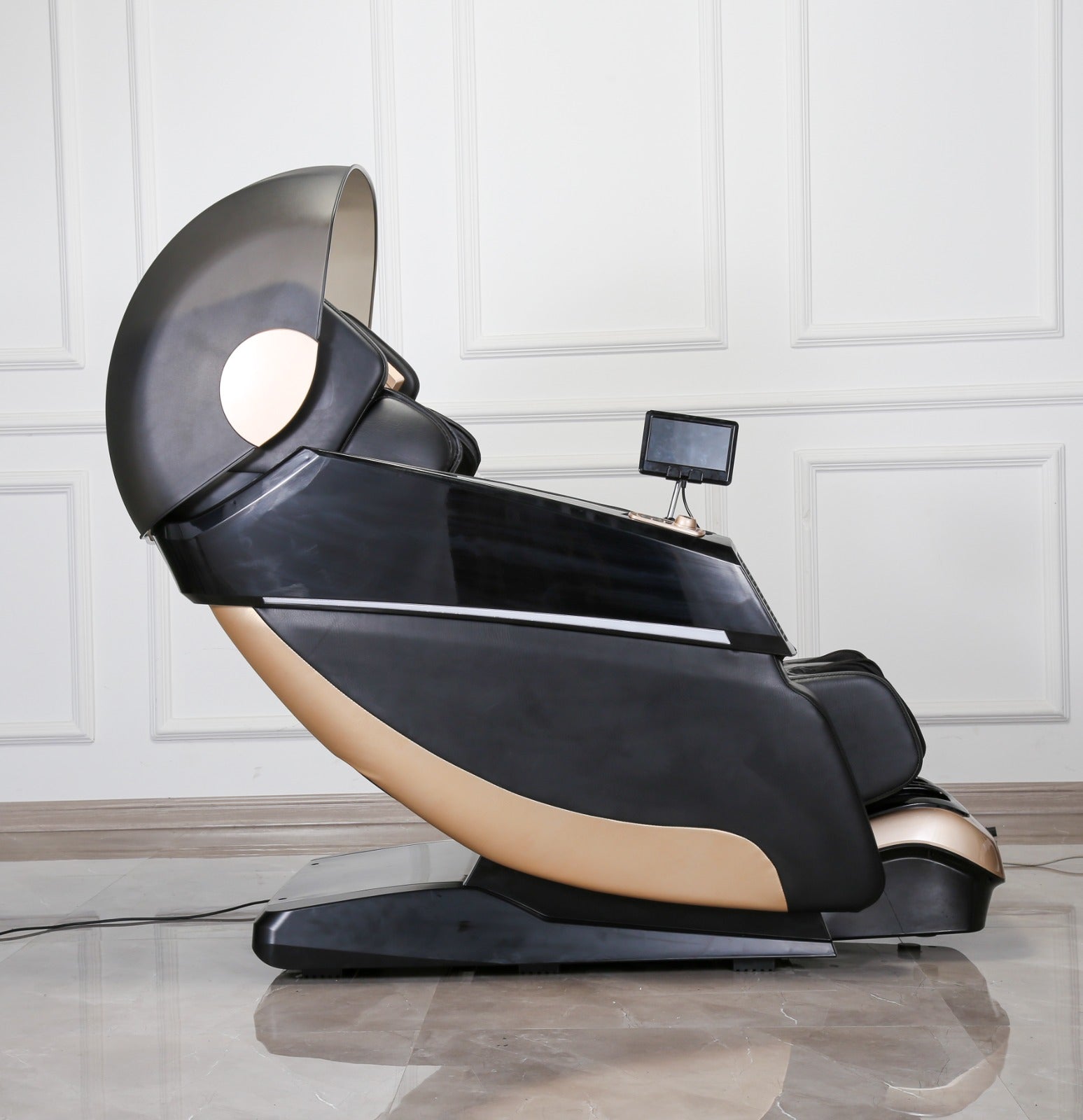 The 4D SL Luxury Voice Control Custom Massage Chair by BefitNow Canada is sleek and modern, with a dark metallic finish for deep tissue massages. It features a reclined seat, small built-in screen, and convenient voice controls, beautifully situated on a shiny tiled floor against a light paneled wall.